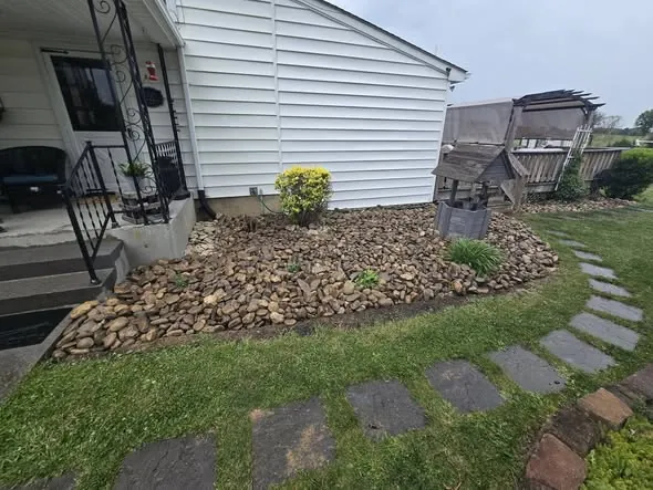 River rock bed and slate stepping stones set alongside a house
