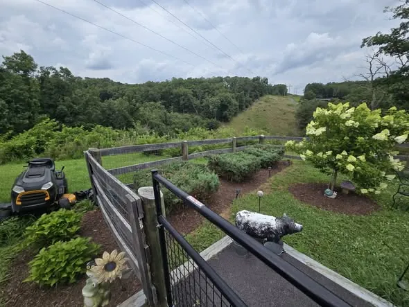 Landscape fabric and river rock being laid along a porch foundation